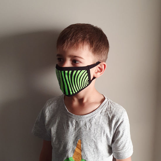 Young boy wearing a green and black striped Australian made face mask