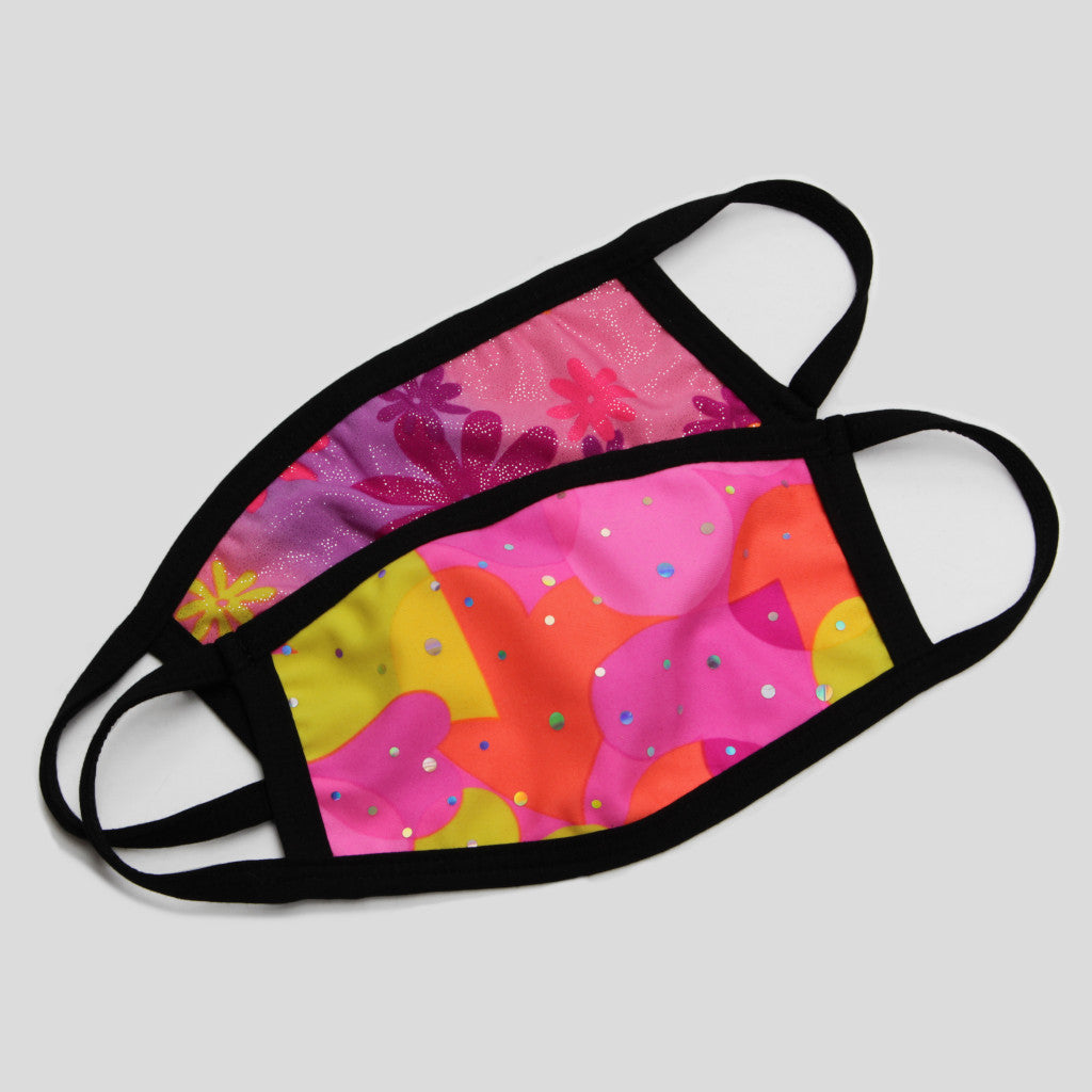 Two children's Australian made fabric face masks where the front mask has a print with pink, orange and yellow hearts overlapping each other