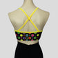 back view of the gold ringed rainbow polka dots print crop top with bright yellow crossover straps