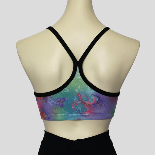 back view of the mystic butterflies print with foil overlay crop top, accented with black straps