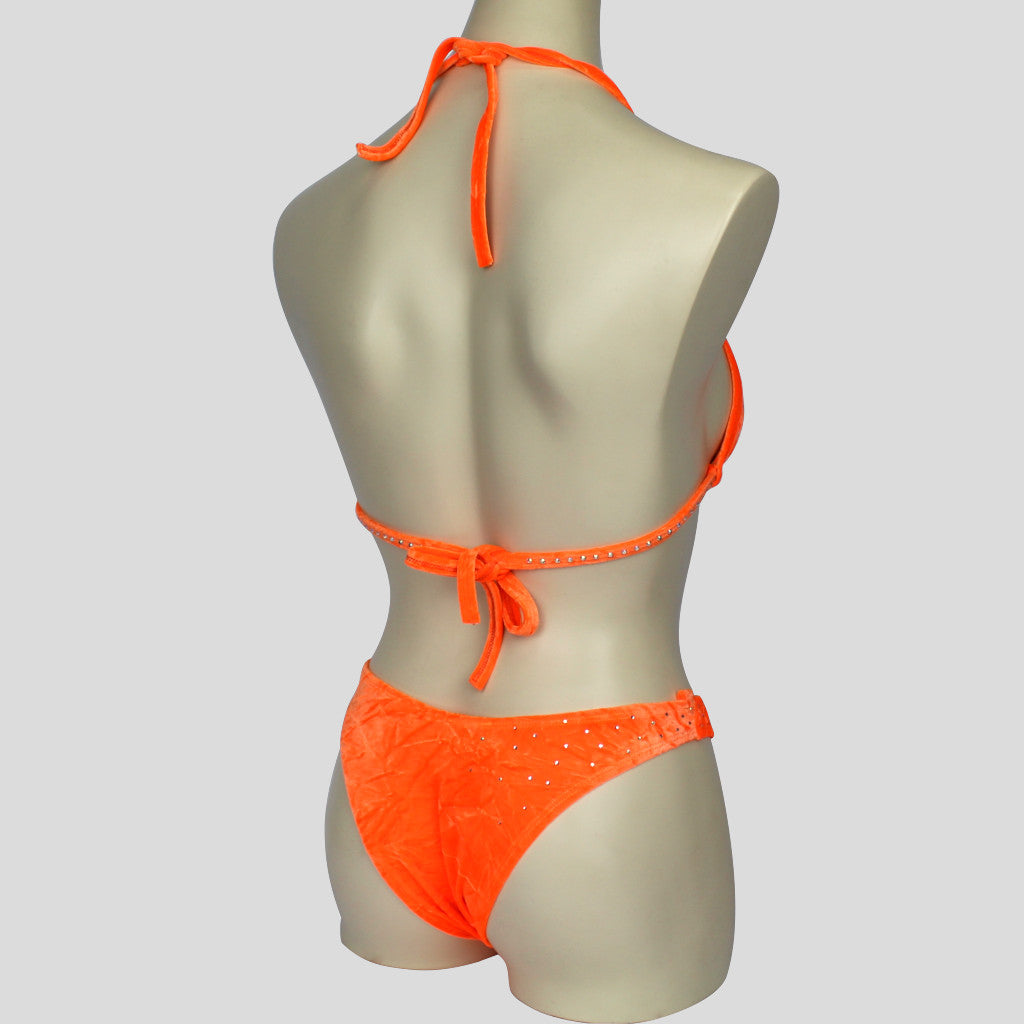 back view of figure bodybuilding bikini in orange with star shaped diamante embellishments and strappy bottoms