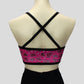 back view of the shimmery pink with silver hearts crop top with crossover black straps
